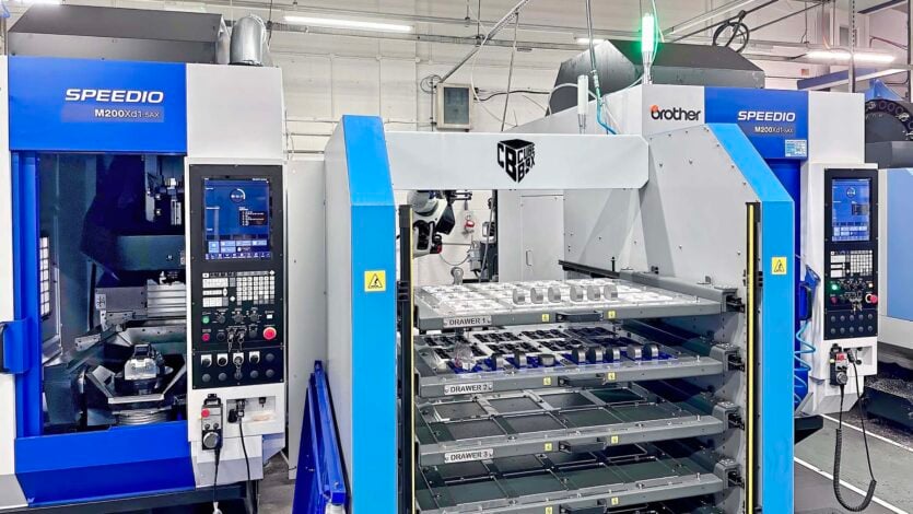 The two Brother Speedio M200Xd1-5AX 5-axis machining centres served by the Tezmaksan robotic workpiece load, unload and storage system on the shop floor at Kirkstall Precision, Leeds.